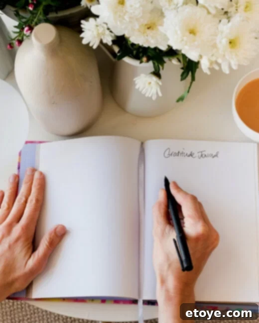 Woman writing in a gratitude journal