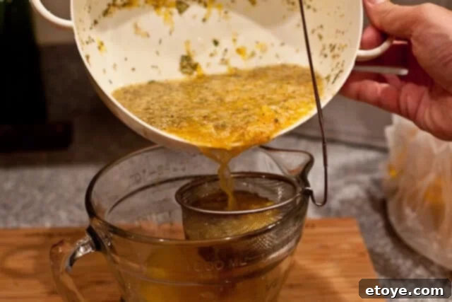 La Caja China Hog Heaven 10 Straining the Mojo Criollo marinade