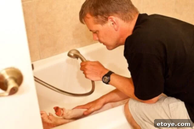 La Caja China Hog Heaven 12 Husband rinsing the pig after scrubbing