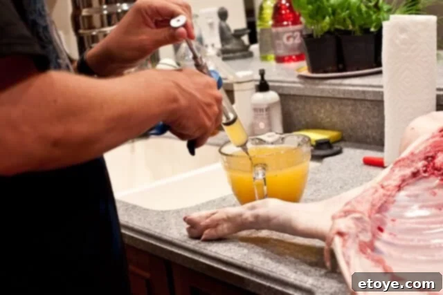 La Caja China Hog Heaven 13 Filling the meat injector with marinade