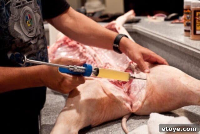 La Caja China Hog Heaven 15 Injecting marinade into the pig