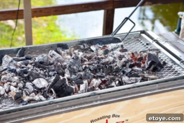 La Caja China Hog Heaven 24 Spreading burning charcoal on La Caja China's tray