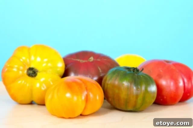 Beautiful Heirloom Tomatoes A colorful assortment of ripe heirloom tomatoes, showcasing their unique varieties