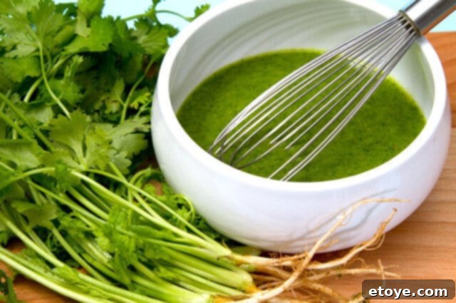 Zesty Cilantro Vinaigrette Spicy cilantro vinaigrette in a clear glass bottle, ready to be drizzled