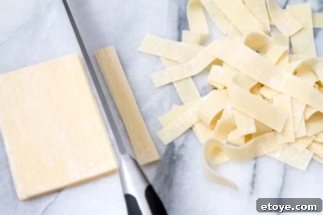 Cutting Wonton Strips Wonton wrappers being cut into thin strips on a cutting board