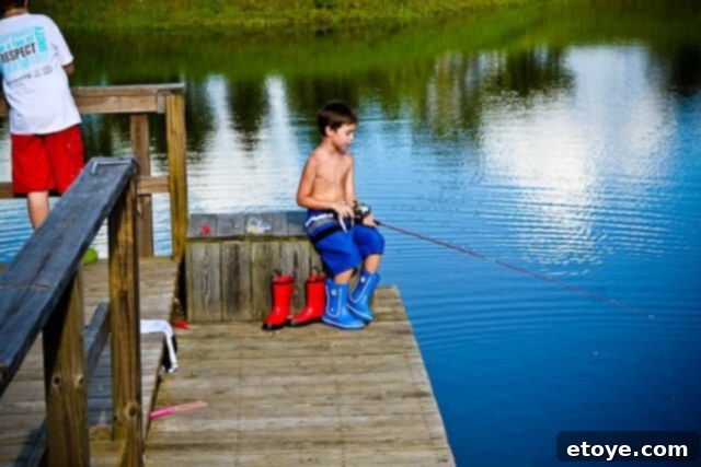 Kids dressed in swimsuits and rain boots, ready to jump into the water for relief from the heat.