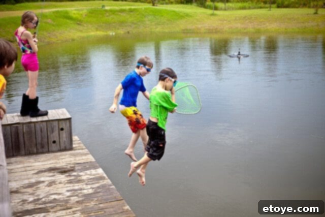 A child proudly holding a tiny bluegill fish, a sweet catch from the fishing trip.
