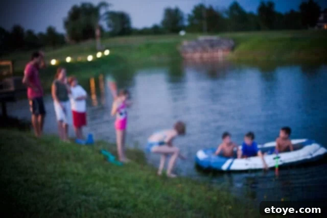 Children laughing and trying to fit more people into the partially inflated raft at night.