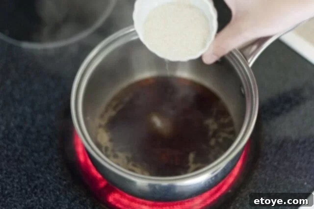 cooking steak_4 Teriyaki sauce simmering in a saucepan on the stovetop.