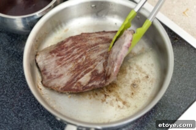 cooking steak_5 Searing flank steak in a hot pan.
