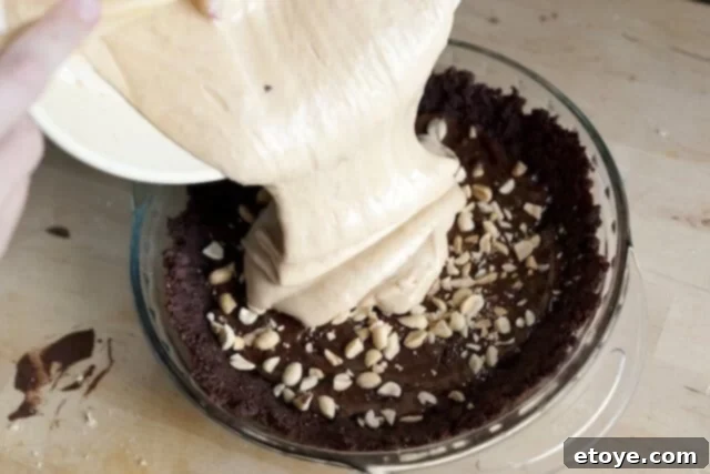 Peanut Butter Pie Top Decorated A whole Peanut Butter Pie, decorated with chocolate shavings and peanuts, ready for refrigeration.