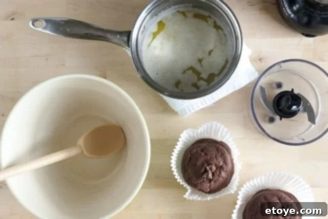 Peanut Butter Pie Crust Mixture Close-up of chocolate cookie crumbs being mixed with melted butter in a bowl.