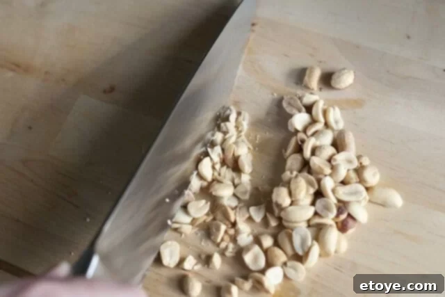 Peanut Butter Pie Peanut Topping Chopped peanuts are sprinkled evenly over the melted chocolate layer in the pie crust.