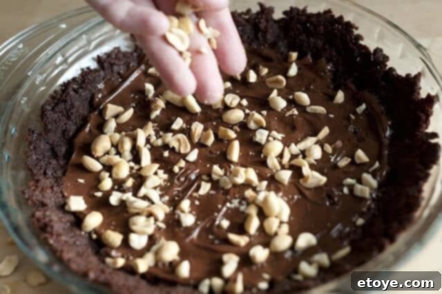 Peanut Butter Pie Whipped Cream Heavy cream is being whipped in a large bowl, forming soft peaks.