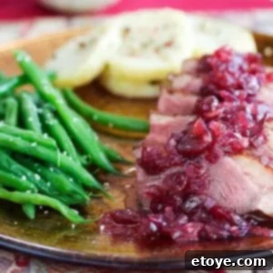 Pan-Seared Duck Breast with Tangy Cranberry Chutney 3 Perfectly sliced duck breast topped with sweet and sour cranberry chutney, alongside vibrant sesame green beans and roasted Yukon potatoes.