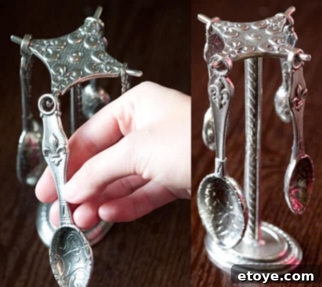 Close-up of Crosby & Taylor Fleur de Lys Measuring Spoons on their Pewter Stand