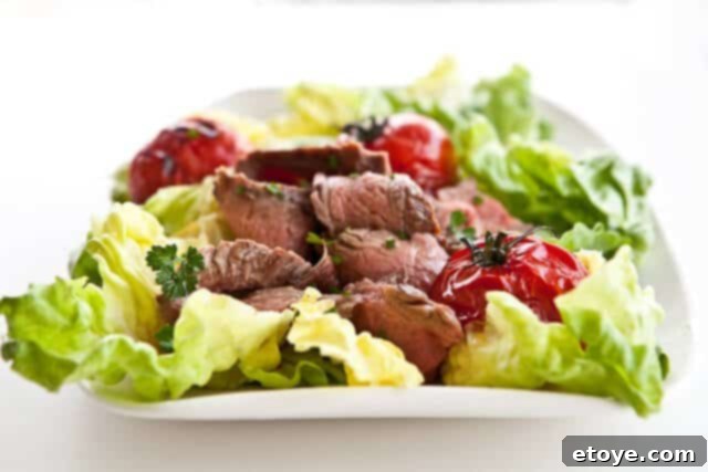 Grilled Steak and Tomato Salad with Rum Vinaigrette, ready to be served on a plate for a gourmet meal