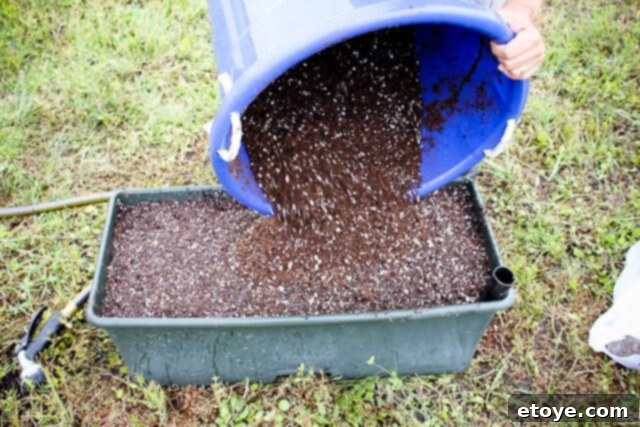 Smart Gardening with Earthboxes 22 Adding the final layer of potting mix to complete the EarthBox filling