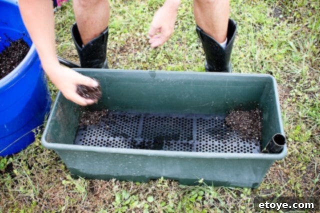 Smart Gardening with Earthboxes 8 Installing the screen and watering tube, then packing wicks in EarthBox