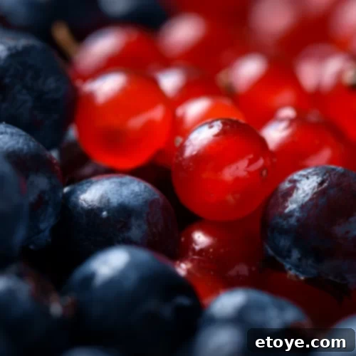 Present Plate 2 A person's hands holding a vibrant green grape, emphasizing sensory awareness in mindful eating