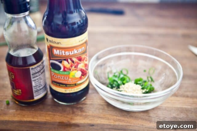 Ingredients for Sesame Ponzu Vinaigrette: sesame oil, ponzu sauce, sesame seeds, and green onions.