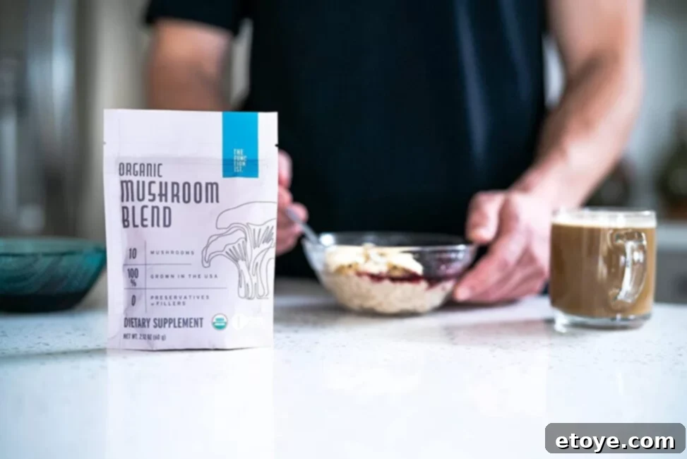 The Functionist Organic Mushroom Blend powder in a jar, surrounded by various mushrooms