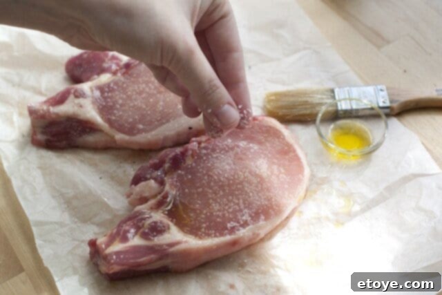 Seasoning Pork Chops with Olive Oil and Salt