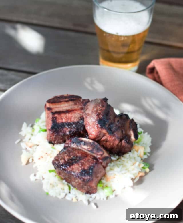 Kalbi Ribs with Macadamia Nut Rice Recipe Presentation Vertical shot of Kalbi Ribs with Macadamia Nut Rice and garnish