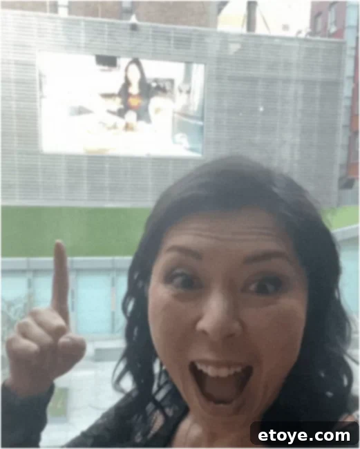 Jaden's NYC Quest 2 Jaden standing proudly in front of a large billboard on 6th Avenue in NYC, featuring her face and promoting Steamy Kitchen.