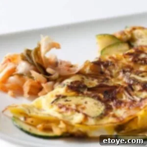 Close-up image of a freshly cooked Kimchi Omelet, fluffy and inviting