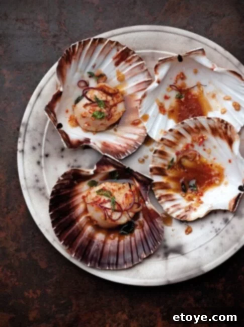 Closeup of freshly cooked Chili and Basil Scallops in a pan