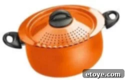 Bialetti Trends Pasta Pot Orange Close-up of the orange Bialetti Trends Pasta Pot, showing the built-in strainer lid