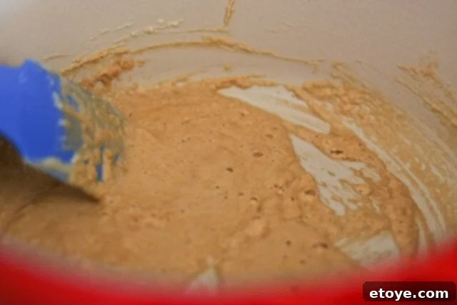 A perfectly cooked roux, the color of peanut butter, showcasing the ideal consistency and hue before adding vegetables.