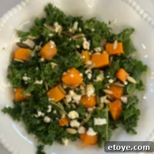 A healthy winter salad recipe featuring roasted butternut squash, fresh kale, and crumbled feta cheese, topped with a flavorful walnut vinaigrette, designed to combat seasonal depression and boost mood.
