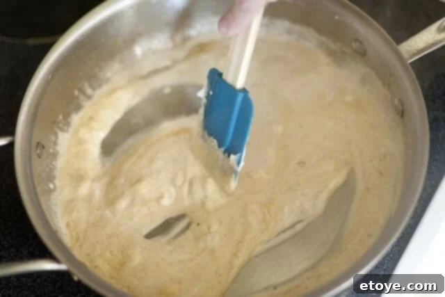 Rich Miso Chicken Pasta 8 Drained pasta and broccoli florets added to the skillet with the creamy miso sauce, ready for tossing.