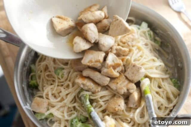 Rich Miso Chicken Pasta 11 A finished serving of creamy miso chicken pasta in a bowl, garnished with finely sliced green onions.