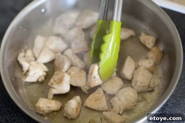 Rich Miso Chicken Pasta 6 Butter melting in a skillet over low heat after chicken has been removed, preparing for the miso sauce base.