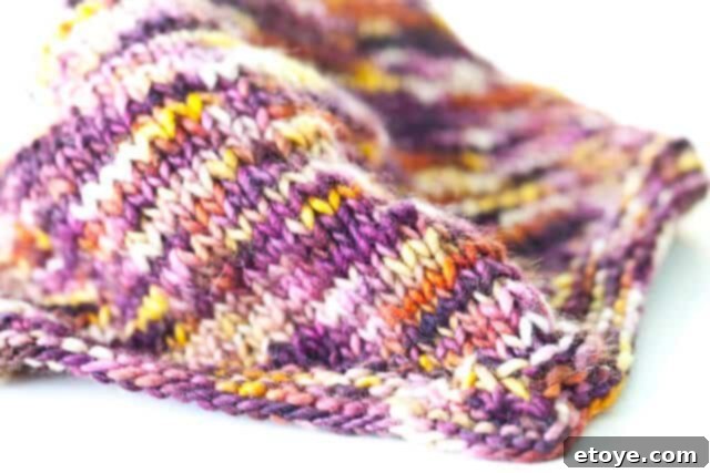 fuzzy-6243 A charming close-up of a fuzzy, knitted scarf in warm autumn colors, symbolizing cozy winter preparations.