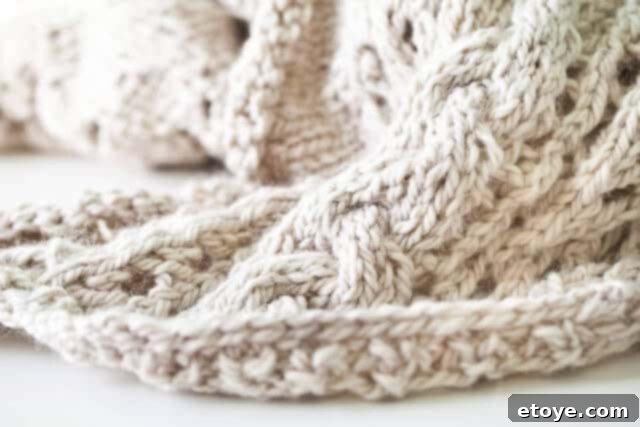 fuzzy-3 A cozy, soft knitted blanket or throw, inviting warmth and comfort, possibly a work in progress.