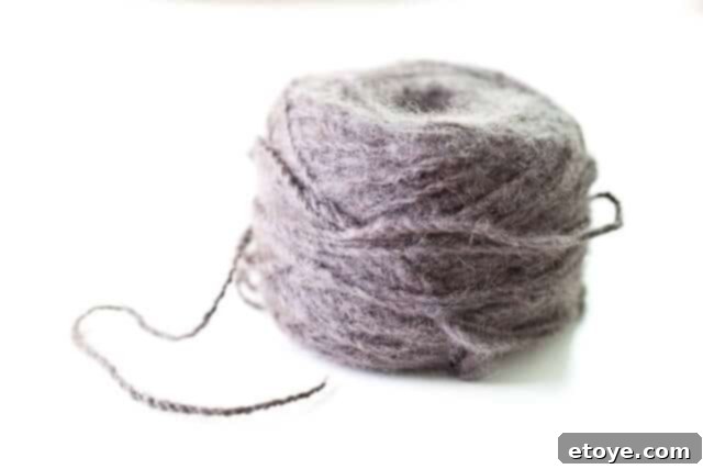 fuzzy-6246 A pile of various fuzzy, knitted garments and accessories, suggesting comfort and warmth, ready for winter.