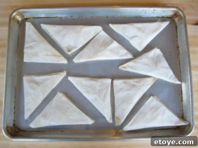 Bourekas on Baking Sheet Unbaked bourekas arranged on a baking sheet, ready for the oven
