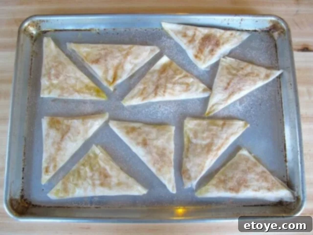 Cinnamon Sugar Sprinkled Bourekas Unbaked bourekas sprinkled with cinnamon sugar on a baking tray