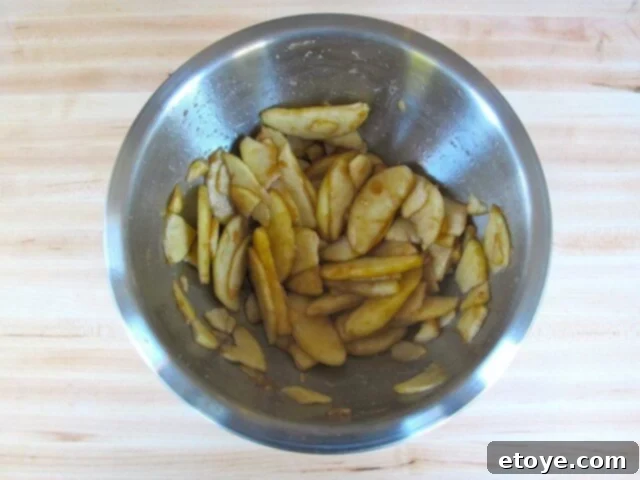 Juicy Apple Filling Mixing bowl with macerated apples, ready for the boureka filling
