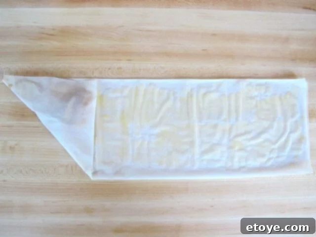 Folding the Boureka First fold of filo dough over apple filling, creating a triangle