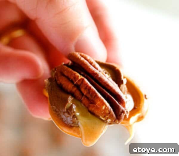 Delicious Rolo Pretzel Turtle with melted caramel and pecan