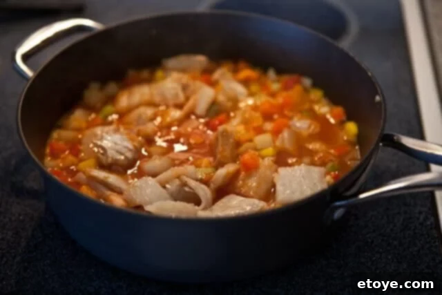 Bacalao recipe stew simmering in a pot with flaked salt cod, potatoes, and vegetables