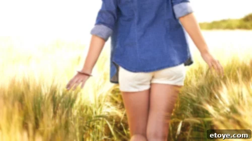 Living With Purpose: The Art of Crafting Magical Moments for Yourself and Others 5 A person enjoying a peaceful walk in a lush green forest, connecting deeply with nature.