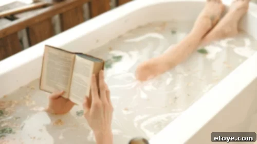 Living With Purpose: The Art of Crafting Magical Moments for Yourself and Others 6 A luxurious bubble bath setup with a wooden tray holding a book, snacks, and a drink – perfect for relaxation.