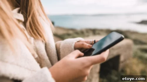 Living With Purpose: The Art of Crafting Magical Moments for Yourself and Others 7 A person texting on a phone, sending a heartfelt message to a loved one.