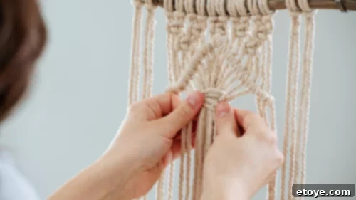 A person skillfully doing macrame, representing the learning of a new craft